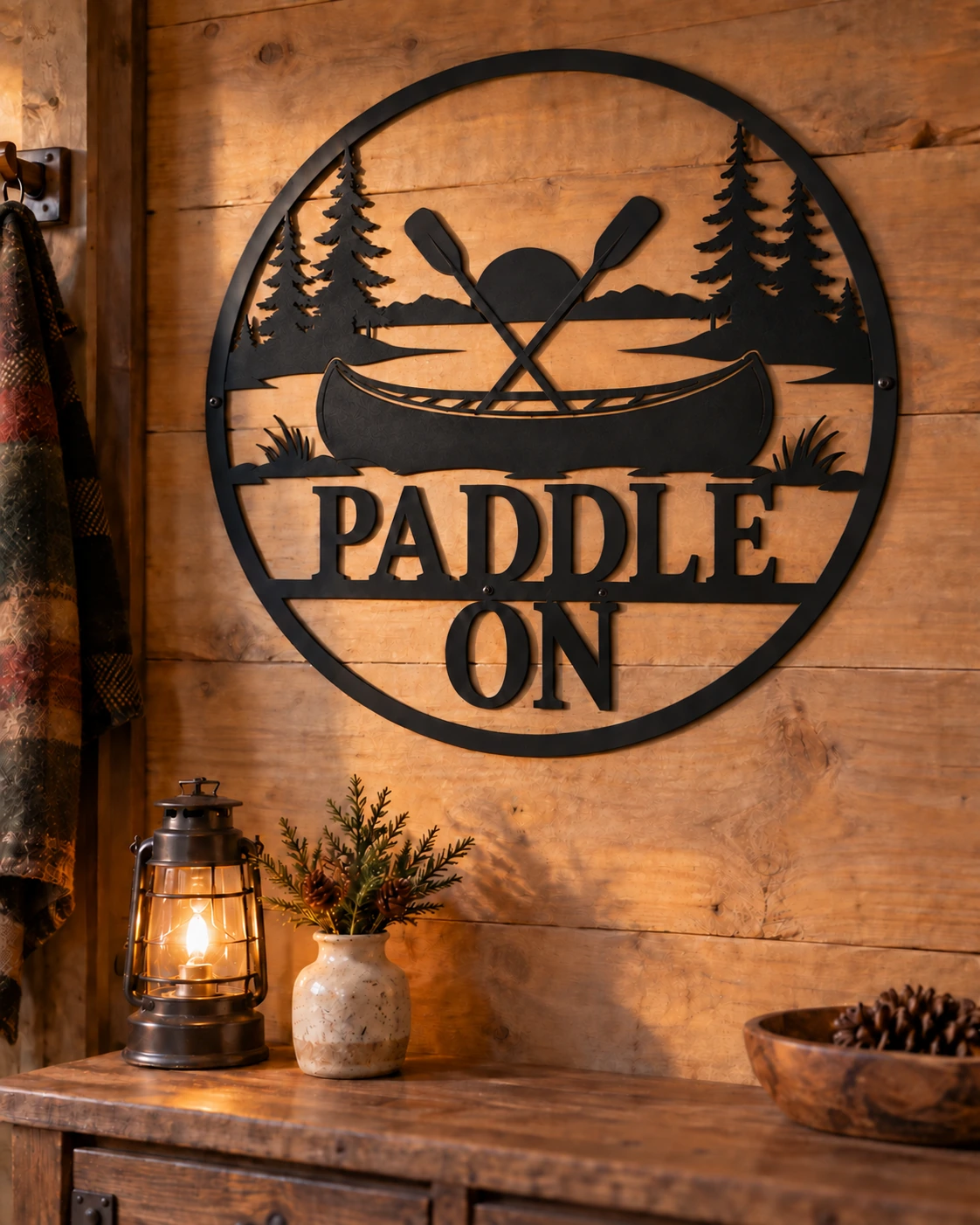 Paddle On black metal sign in a warm rustic cottage setting