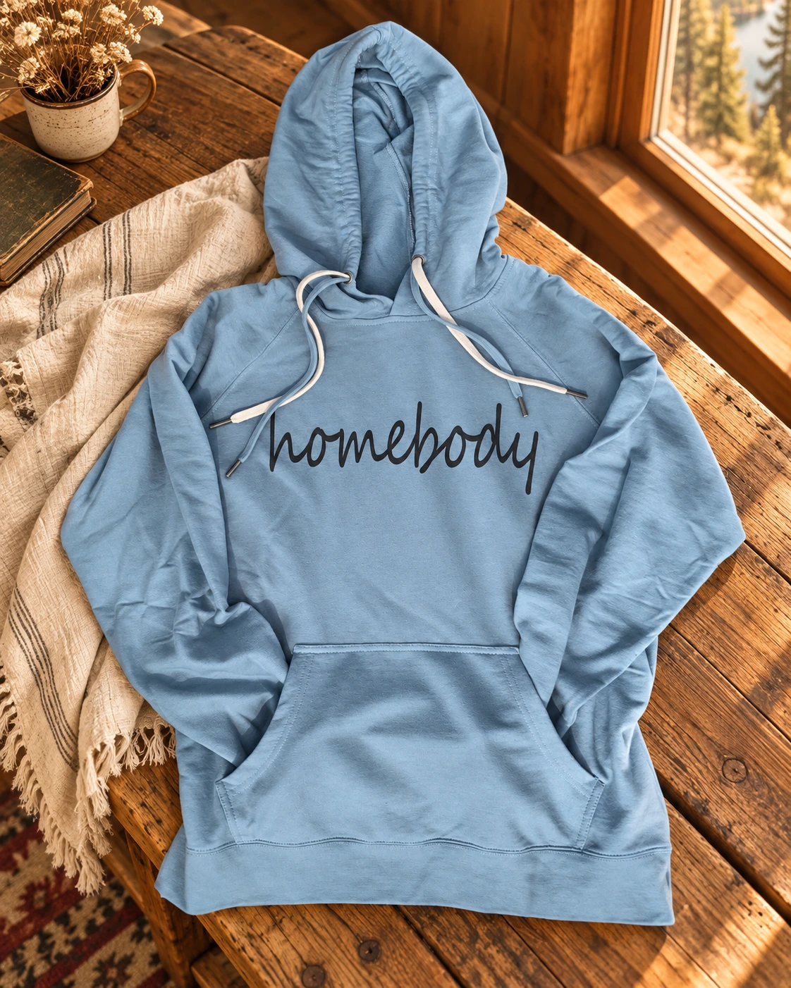 Homebody Hoodie or T-Shirt displayed in a warm styled setting