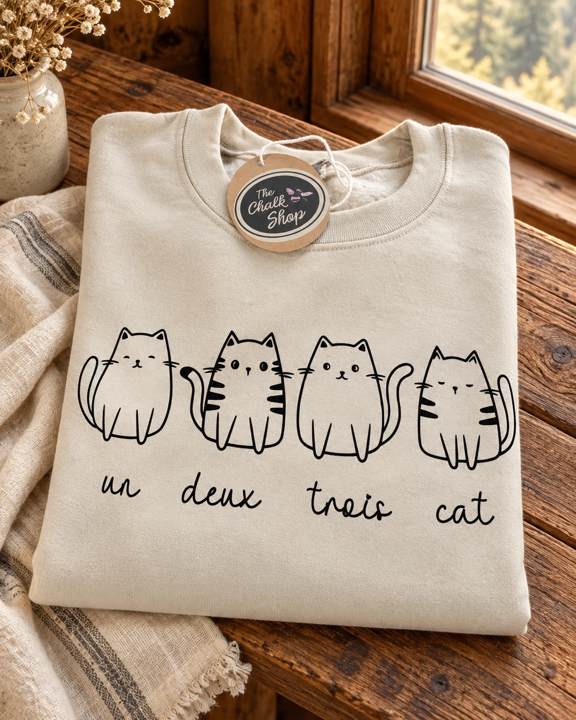 Un deux trois cat Hoodie or T-Shirt displayed in a warm styled setting